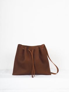 "Brown medi leather crossbody bag minimalist, Handmade leather bag, hygge leather bags, women crossbody bag, ethical bags, sustainable gifts. Cognac brown leather Origen bag Medium size. The origin collection is the simplest and purest of all my designs, the high quality of the leather and its simple lines make each bag special and unique. The medium origin leather bag is your perfect size for your everyday, traveling or going out. You can carry it over the shoulder or across the body, since the Minimalist Leather Shoulder Bucket Bag, Minimalist Leather Crossbody Bucket Bag, Minimalist Crossbody Hobo Bag, Minimalist Satchel With Leather Handles, Minimalist Hobo Bag With Adjustable Strap, Everyday Vegetable-tanned Crossbody Satchel, Minimalist Textured Leather Shoulder Bag, Minimalist Leather Shoulder Bag, Vegetable-tanned, Minimalist Leather Hobo Bag