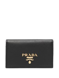 Known for its classical Italian goods and creative edge styling, Prada produces timeless chic and sophisticated designs in every clothing line. Showcasing a perfect example of the brand's expert craftsmanship is this piece. Crafted from calf leather, this black Saffiano cardholder from Prada features a front logo plaque, a snap button closure and multiple card slots. Formal Rectangular Wallet With Logo, Luxury Rectangular Wallet With Logo, Luxury Rectangular Wallets With Logo, Designer Business Wallets With Logo, Designer Business Wallet With Logo, Elegant Wallets With Gold-tone Logo Plaque, Designer Logo Wallets For Formal Occasions, Designer Wallets With Engraved Logo For Professional Use, Luxury Rectangular Wallet With Gold-tone Logo