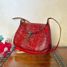 "MADE IN MEXICO By: Mexican Artisans For: Women Color: red Dimensions: 9.5 x 8 x 2.5 Details: - 100% Authentic Leather - Style: Crossbody | Shoulder Bag - Embossed Design - Hook lock closure - Adjustable & Non-Removable Strap: 22\" Drop Contact us for more details PLEASE READ BEFORE PURCHASE: The picture is an ACCURATE REPRESENTATION. Colors in the pictures may vary a little by effects of light. Each product is handmade from Mexico causing differentiation and minor imperfections in each piece making them that much more unique. We strive to have consistency within our business but please be aware not all pieces are 100% alike. Please Read our Return Policy to learn more about returning or exchanging purchased items" Red Flap Bag With Mobile Phone Bag For Travel, Red Flap Bag With Mobile Phone Pocket For Travel, Red Flap Bag With Mobile Phone Holder For Travel, Red Crossbody Flap Bag, Red Satchel Shoulder Bag With Mobile Phone Pocket, Red Rectangular Flap Bag With Mobile Phone Holder, Red Rectangular Flap Bag For Mobile Phone, Red Crossbody Flap Bag With Adjustable Strap, Red Crossbody Flap Bag For Travel