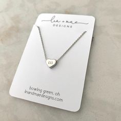 "Dainty Hand Stamped Initial Heart Necklace This hand stamped heart charm necklace makes the perfect gift! Stamp in your kids, grandkids, nieces, nephews, god-child's (or any child!) initials for a one-of-a-kind, keepsake accessory. Be sure to include what initial you would like stamped in the heart charm in the comments section when ordering!! Each heart charm finish will match the finish of the necklace chosen unless otherwise requested Listing for one necklace in Rose Gold, Silver or Gold fin Simple Hand Stamped Necklace As Gift, White Necklace With Heart Charm For Birthday, Cute Personalized Everyday Jewelry, Cute Everyday Personalized Jewelry, Personalized White Heart Necklace For Mother's Day, Dainty Charm Necklace For Mother's Day Personalized Gift, White Heart Necklace With Charm For Birthday, Simple Personalized Charm Necklaces For Mother's Day, Simple Personalized Charm Necklace For Mother's Day