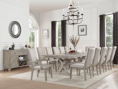 a dining room table with chairs and a chandelier