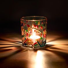 a lit candle sitting on top of a table