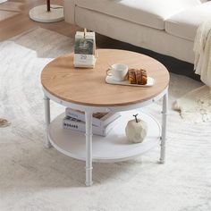 a white coffee table with a wooden top in a living room next to a couch