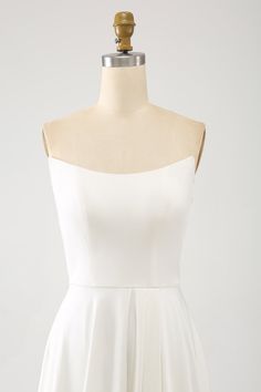 a white dress on a mannequin neckline with an open back and straps