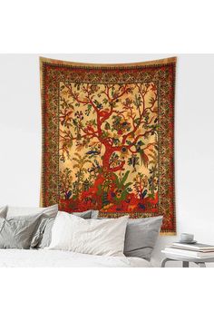 a tapestry hanging on the wall above a bed