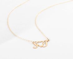 "Beautiful Initial Heart Initial Pendant Necklace. 𝘼 𝙗𝙚𝙖𝙪𝙩𝙞𝙛𝙪𝙡 𝙨𝙤𝙥𝙝𝙞𝙨𝙩𝙞𝙘𝙖𝙩𝙚𝙙 𝙥𝙞𝙚𝙘𝙚, 𝙬𝙞𝙩𝙝𝙤𝙪𝙩 𝙖 𝙝𝙪𝙜𝙚 𝙥𝙧𝙞𝙘𝙚 𝙩𝙖𝙜! 𝙋𝙧𝙚𝙢𝙞𝙪𝙢 𝙃𝙞𝙜𝙝 𝙌𝙪𝙖𝙡𝙞𝙩𝙮 𝙛𝙤𝙧 𝙖 𝙡𝙞𝙛𝙚𝙩𝙞𝙢𝙚 𝙤𝙛 𝙝𝙖𝙥𝙥𝙞𝙣𝙚𝙨𝙨. :) The Perfect Necklace for everyday wear! This necklace features beautiful initials (of your choice) cut out with a heart shape inbetween that hangs from a dainty and shimmering chain. This necklace is a subtle way to make a statement. This necklace is also the ultimate gift as you can guarantee much appreciation of it!  - We use the Highest Quality materials from the US and Italy. - Your purchase will come packaged in a lovely Jewelry Box ----------------------------------- O R D E R * D E T A I L S * 25mm x 13mm Heart Cut Out pendant (exact s Elegant Heart Necklace For Valentine's Day Birthday, Elegant Heart Necklace For Birthday And Valentine's Day, Elegant Heart Pendant Necklace For Birthday, Initials Heart Necklace For Anniversary On Valentine's Day, Elegant Heart Charm Necklace For Birthday, Initials Heart Necklace For Valentine's Day Anniversary, Elegant Heart Necklace For Birthday And Mother's Day, Personalized Elegant Heart Necklace For Birthday, Valentine's Day Wedding Heart Necklace With Initial Pendant