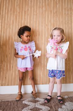 Introducing our newest blouse and short set! This adorable two-piece features a beautiful floral embroidered cotton blouse, paired with colorful block print shorts with little lace trim. She'll look absolutely precious in this ensemble - perfect for a day of play! Print Shorts, Cotton Blouse, Short Set, Cotton Blouses, Printed Shorts, Short Sets, Block Print, White Blue, Lace Trim