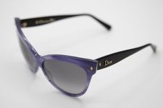 "Dior women's sunglasses from collection \"Les Marquises\" Mohotani, featuring a timeless 1960s style, with a pointy cat eye frame in purple and gradient grey lenses and details in gold. Made in Italy. Excellent conditions. New old stock, never worn. HQ UV-protection lenses. Dior \"Les Marquises\" Mohotani collection Lens Width: 58mm - 2,28 inches Overall Width: 143m - 5,63 inches Lens Height: 47mm - 1,85 inches Safely shipped with UPS worldwide. All our frames come with a sunglasses case and a 2000s Sunglasses, Sunglasses Purple, Purple Retro, 1960s Style, 60s Style, Retro 60s, Vintage Eyewear, Vintage Glasses, 1960s Fashion