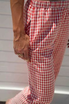 Score trendy Gingham Pants made of cotton canvas in a red check pattern. Designed with a comfy fit and a low waist, these bottoms will elevate your look when worn with a top and stylish boots or heels. pants 50% cotton 50% polyester lininig 100% rayon gingham print inner drawstring tie elastic waistband double pocket at back non stretch fully lined MODEL DETAILS: Height 6’1 Bust 34DD Waist 28 wearing size small Gingham Cotton Pants, Casual Plaid Pants For Picnic, Summer Cotton Pants For Picnic, Summer Picnic Cotton Pants, Summer Gingham Pants For Picnic, Red Bottoms For Spring Picnic, Red Spring Bottoms For Picnic, Red Bottoms For Summer Picnic, Red Summer Bottoms For Picnic