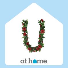 the letter u is decorated with red flowers and greenery in front of a blue background