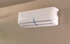 a white air conditioner mounted to the side of a wall