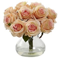 a vase filled with lots of pink roses