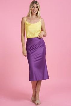 Introducing our luxurious purple satin midi skirt, the perfect addition to any fashion-forward wardrobe. Crafted from high-quality satin fabric, this skirt boasts a lustrous sheen and a silky-smooth texture that feels incredibly soft against the skin. Designed with a flattering midi length, this skirt falls elegantly to the mid-calf, making it a versatile piece that can be dressed up or down for any occasion. The deep shade of purple adds a bold and sophisticated touch to any outfit, making it a Elegant Purple Satin Bottoms, Summer Satin Skirt For Night Out, Purple Satin Skirt For Party, Purple Satin Party Skirt, Satin Midi Skirt With Lining, Spring Satin Skirt For Night Out, Satin Midi-length Bottoms For Party, Satin Midi-length Party Bottoms, Summer Satin Dress With Flared Skirt