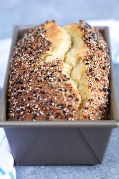 a loaf of sesame seed bread in a pan