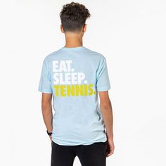 Wear your favorite tennis design on the BACK of your shirt with a smaller design on the front. Show off your tennis pride with this bold and stylized short sleeve tennis t-shirt. It's a great tennis gift idea for any player who just can't get enough of that tennis lifestyle. It makes for the perfect end of season gift or any special occasion. Coming in a variety of colors and unique designs these are a great wardrobe collection. Sporty Graphic T-shirt For Sports, Cotton Short Sleeve T-shirt For Tennis, White Graphic Tennis T-shirt, Sporty Screen Print T-shirt For Tennis, Sporty Blue Tennis Tops, Blue Sporty Tops For Tennis, Blue Casual Tennis Top, Blue Sports T-shirt With Text Print, Sports Cotton T-shirt With Branding