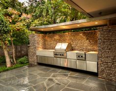 an outdoor kitchen with stainless steel appliances