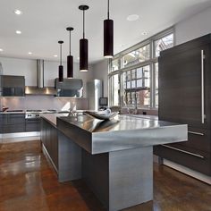 a large kitchen with stainless steel appliances and wood floors