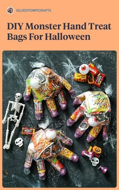 halloween decorations made out of candy bags and skeleton hands on top of a black surface