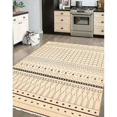 a kitchen with an oven, stove and rug on the floor in front of it