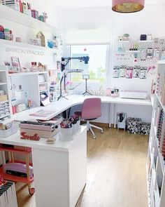 an office with lots of crafting supplies on the desk and shelves in front of it