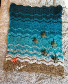 there is a knitted blanket with sea turtles on it