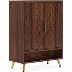 a wooden cabinet with two doors and gold handles