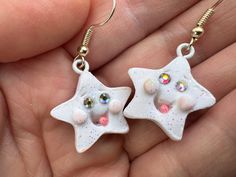 Cute star dangle earrings with rhinestone eyes, glitter white polymer clay. Made with good vibes😊and lots of love💗 Handmade White Star Jewelry, White Star-shaped Handmade Jewelry, Whimsical White Resin Jewelry, White Star-shaped Earrings As Gift, Whimsical White Hypoallergenic Earrings, White Sparkling Earrings As A Gift, White Star Charm Earrings As Gift, White Star-shaped Earrings With Star Charm, White Star-shaped Nickel-free Earrings