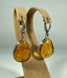 Elevate your style with our Handmade Earrings featuring spectacular orange amber set in textured 925 sterling silver. These exquisite earrings are designed for women who appreciate unique and original jewelry. The vibrant orange amber stones are beautifully complemented by the textured silver, creating a stunning and eye-catching piece that adds a touch of elegance and sophistication to any outfit. Product Details: Material: 925 Sterling Silver Stone: Orange Design: Textured Silver with Unique S Orange Design, Amber Earrings, Amber Stone, Wedding Jewelry Earrings, Original Jewelry, Amber Jewelry, Vibrant Orange, Elegant Gift, Wedding Earrings