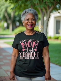 Represent your black culture in a comfortable and durable way with our Two Titles - Mom and Grandma Tee. Made from 100% airlume soft cotton, this one-of-a-kind shirt is perfect for celebrating Mother's Day. Orders are shipped within 3-5 business days. Black Screen Print T-shirt For Mother's Day, Mother's Day Black T-shirt With Screen Print, Black Crew Neck Tops For Mother's Day, Black Tops With Letter Print For Mother's Day, Mother's Day Black Tops With Graphic Print, Black Graphic Print T-shirt For Mother's Day, Funny Black T-shirt For Mother's Day, Black T-shirt With Funny Text For Mother's Day, Mom Funny