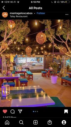 an image of a restaurant with lights on the ceiling and tables set up for people to eat