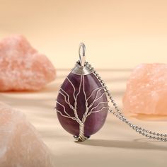 PLEASE NOTE: Our crystal stones are natural minerals and each crystal is unique. The internal ice cracks, pits, mineral points, and color differences of natural crystals are all formed naturally and are normal phenomena, which will not affect the efficacy, beauty and value of the crystal at all.This necklace is probably the most beautiful piece of jewelry you'll ever see. The intricate tree design weaved around the gorgeous purple crystal adds to this necklace's charm. Wear this magical piece ar Rose Quartz Pendant Crystal Necklace With Natural Stones, Rose Quartz Pendant Necklace With Natural Stones, Amber Crystal Necklace With Natural Stones For Healing, Rose Quartz Crystal Necklace As Gift, Teardrop Crystal Stones Necklace For Gift, Natural Stone Crystal Pendant, Natural Stone Pendant Crystal, Natural Stone Pendant Crystal Necklace, Fluorite Natural Stones Crystals For Healing