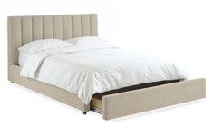 an upholstered bed frame with white sheets and pillows on the headboard is shown