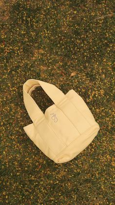 Description This Classic Canvas Mini Tote is a must-have for your daily errands, grocery runs, workouts, or office needs. Its sturdy canvas material comes in two colors - butter yellow and contrast - and will stay upright no matter where you take it. butter: short strap contrast: long strap Material 24 oz. Canvas Measurements: 10x10x4.5in Office Needs, Butter Yellow, Mini Tote, Classic Mini, Sewing Ideas, Canvas Material, Matter, Butter, Pouch