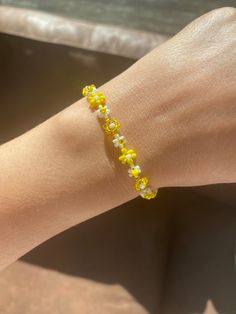 Yellow bead bracelet with a delicate design. The Floral Daisy Bracelet will brighten up your look. A beaded bracelet crafted by hand with high-quality beads.  Thank you very much for visiting our shop. We hope you have a great shopping experience! If you are struggling to find the information you need, please feel free to contact us. Do not forget to take a look at our other products in our shop. 😊 Yellow And White Beaded Bracelets, Cheap Elegant Yellow Beaded Bracelets, Yellow Bead Bracelet Ideas, Spring Beaded Bracelets With Flower Shape And Tiny Beads, Spring Beaded Bracelets With Tiny Flower Beads, Yellow Beaded Chain Bracelets, Yellow Beaded Chain Bracelet, Spring Flower Beaded Bracelets With Tiny Beads, Dainty Spring Beaded Bracelets