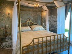 a bedroom with a canopy bed and chandelier