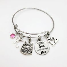 a silver bracelet with charms on it that says sugar, sweet and everything nice in english