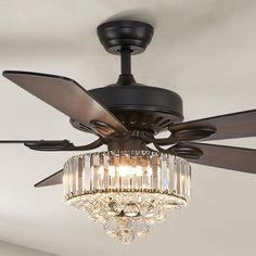 a ceiling fan with crystal chandelier hanging from it