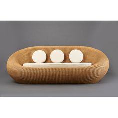 three white round objects sitting on top of a wooden table next to a gray wall