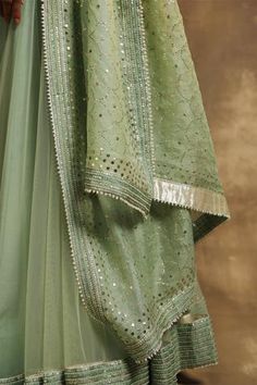 Shop for Karishma Khanduja Bareilly Green Net Embroidered Lehenga Set for Women Online at Aza Fashions Pista Green Dupatta With Zari Work For Reception, Green Salwar Kameez With Mirror Work For Reception, Green Unstitched Choli With Mirror Work, Unstitched Green Choli With Mirror Work, Green Dola Silk Palazzo Set With Mirror Work, Green Mirror Work Palazzo Set For Reception, Pista Green Salwar Kameez With Mirror Work For Reception, Pista Green Palazzo Set With Mirror Work For Reception, Green Chinon Set With Sheer Dupatta