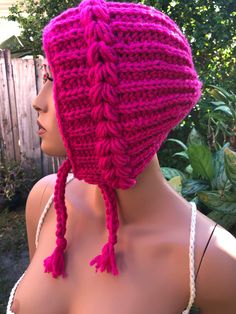 a mannequin wearing a pink knitted hat