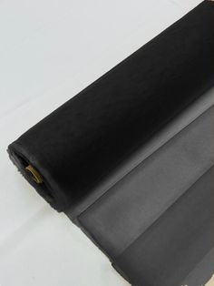 a roll of black fabric sitting on top of a table