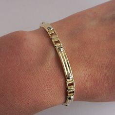 "This vintage bracelet is 14Kyellow gold with 14K White Gold screw top accents, with a heavy lobster claw clasp. This bracelet is 8\" long. It is of hollow construction. Bracelet Length: 8\" Total Weight: 14.5g These pieces are pre-owned vintage jewelry. As this jewelry is not new there may be signs of wear or age. Each piece is sold as-is unless otherwise specified (ex. sizing). We strive to only sell vintage jewelry that is in good wearable condition. As with any jewelry, care and proper maint Long Bracelet, 18k Gold Bracelet, Rose Bracelet, Green Jewelry, Silver Chain Bracelet, Vintage Bracelet, Sterling Silver Cuff Bracelet, Yellow Gold Bracelet, Sterling Silver Cuff