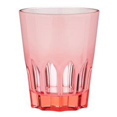 a pink glass filled with lots of small pieces of furniture on top of a white surface