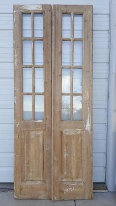 two wooden double doors sitting next to each other