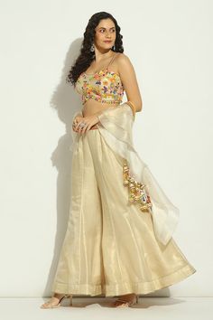 Gold, beige padded blouse with multicolor bead, sequin, shell drops embroidery in floral pattern. Paired with waistband embroidered panelled attached cancan sharara and border embroidered dupatta. - Aza Fashions Festive Embellished Beige Sharara, Festive Beige Embellished Sharara, Festive Embellished Beige Sets, Beige Party Set With Mirror Work, Beige Party Sets With Mirror Work, Gold Dupatta With Pearl Embroidery, Embellished Multicolor Silk Sharara, Beige Sharara For Party, Elegant Embellished Multicolor Choli