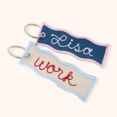 two key chains with the word work on them