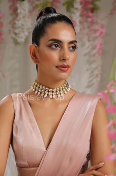 The Kundan necklace set with sea pearls is an ode to the rich old traditions of India handcrafted by the artisans to celebrate beauty with heritage. The bold and bright design of the Kundan necklace has a glimpse of Bollywood jewelry, perfect for the woman of today. Pair this gold-plated kundan necklace with your ethnic or contemporary ensembles and create a look to remember.  Necklace Closure - Adjustable Dori   Earrings Closure - Push Back Style Tip - Being a strong supporter of the intersection of classic and contemporary, we love designs that are contemporary yet boast hints of traditional charm. This necklace set can be a great pair for traditional sarees, indo-western dresses, or even a power suit.  Handcrafted in Jammu and Kashmir Paisley Pop travels the depths of India to learn tec Timeless Jewellery, Kundan Necklace Set, Kundan Jewelry, Indo Western Dress, Kundan Necklace, Bollywood Jewelry, Jewelry Indian, Kundan Necklaces, Traditional Sarees