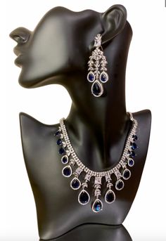 Add some sparkle to any occasion with our CZ American Diamond Necklace. Perfect for weddings, parties, or as a gift for her. This stunning necklace, made with beautiful bluestones, will elevate any outfit like sarees, gowns, or lehengas. Make a statement with this beautiful and versatile piece. This jewellery set includes a necklace and matching earrings. Jewellery Care- Keep the jewellery dry, avoid contact with perfumes and water. Formal Bollywood Necklace With American Diamond, Bollywood Style Elegant Jewelry Sets For Formal Occasions, Traditional Blue Bridal Necklace For Formal Occasions, Bollywood Style Necklace With American Diamond For Parties, Bollywood Style American Diamond Necklaces For Party, Formal American Diamond Necklaces For Diwali, Elegant Heavy Kundan Necklace For Party, Bollywood Style American Diamond Necklace For Parties, Bollywood Style Elegant Necklaces For Formal Occasions