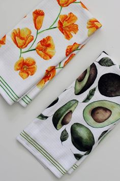 two avocado printed napkins sitting next to each other on a white surface