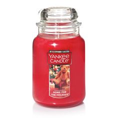 yankee candle home for the holidays with teddy bear image on front and back lid, in red glass jar